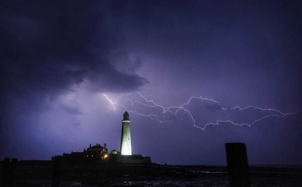 Lightning strikes near St Mary's Lighthouse in Whitley Bay, north east England, as more rain and thunderstorms brought further flood warnings across the UK. Picture date: Monday August 5, 2019. See PA story WEATHER Rain. Photo credit should read: Owen Humphreys/PA Wire