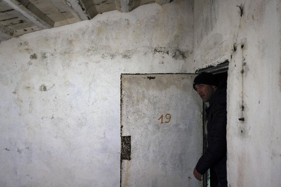 Tourist guide Afrim Cenaj shows the underground tunnels beneath the city of Kukes, north of Tirana, Albania, Wednesday, March 15, 2023. Authorities, assisted from the European Union, plan to rehabilitate the tunnel network and show to tourists how residents would live for six months in a similar town underneath. (AP Photo/Franc Zhurda)
