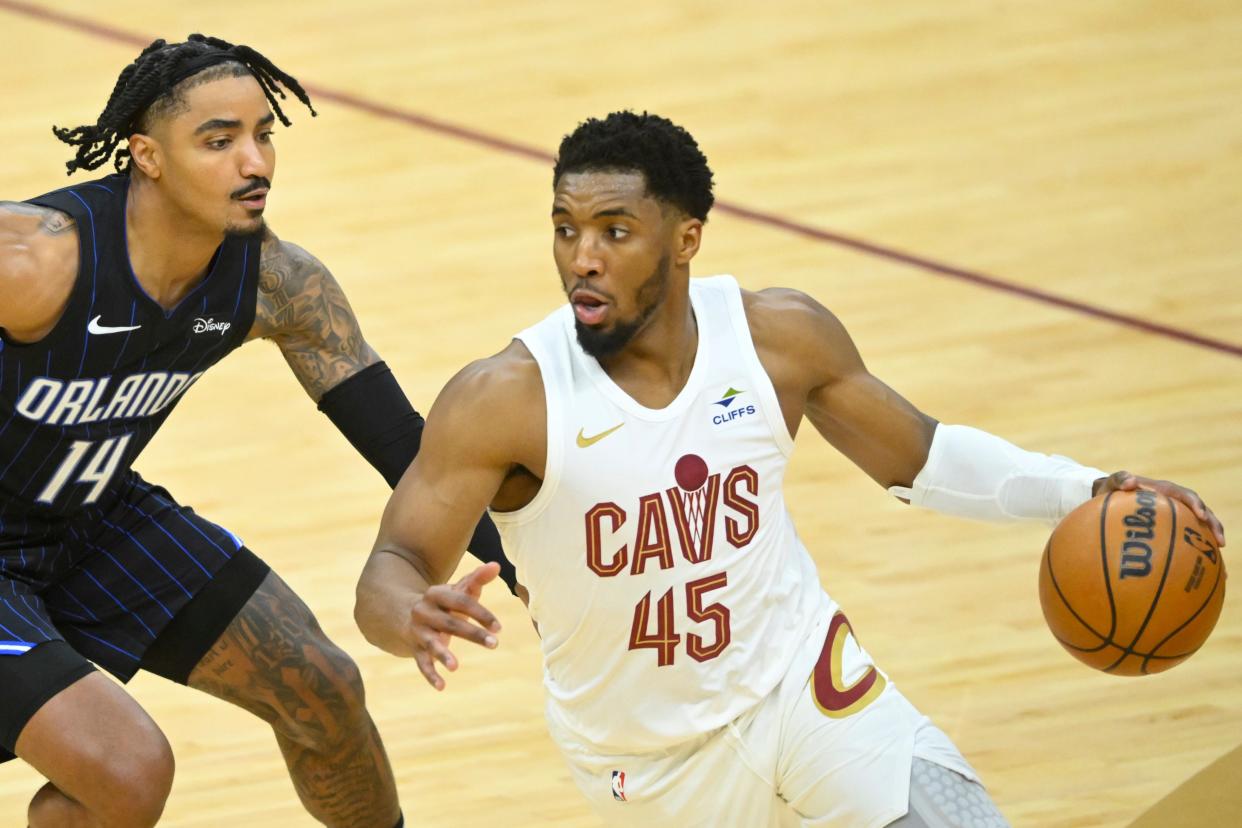 Orlando Magic guard Gary Harris (14) defends Cleveland Cavaliers guard Donovan Mitchell (45) in the fourth quarter during Game 1 of a 2024 NBA first-round playoff series Saturday in Cleveland.