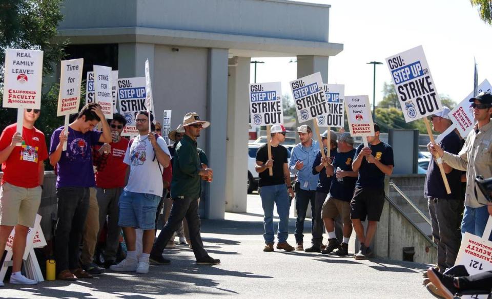 Members of the California Faculty Association picket outside a Cal Poly alumni event at the Performing Arts Center on Friday, Oct. 27, 2023, in support of higher state university salaries.