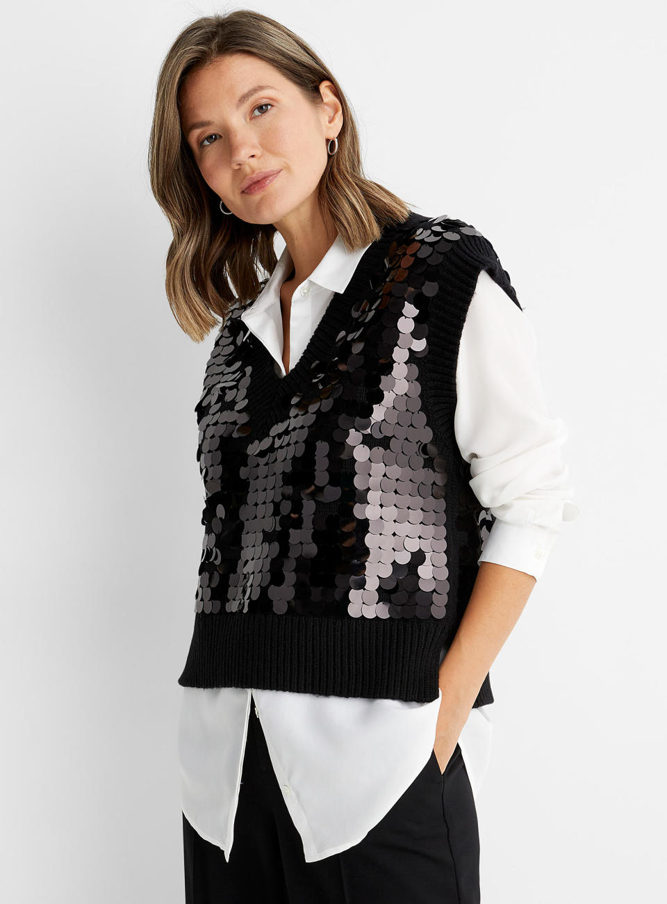 Model wears Sequin V-neck Sweater Vest in black