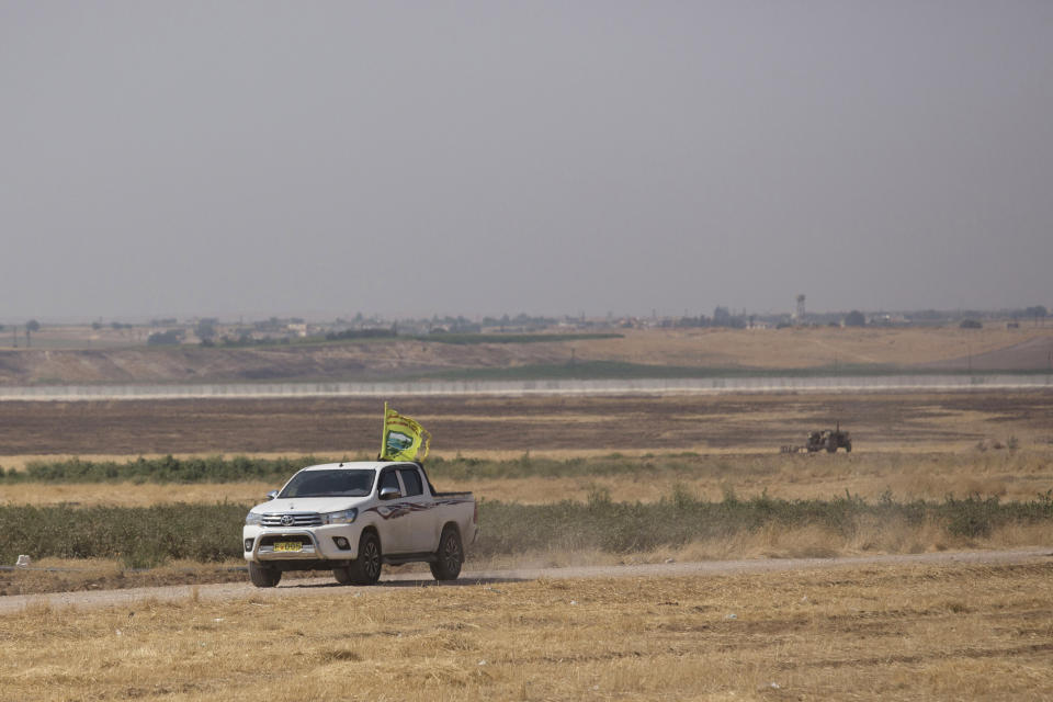 A truck flying the new flag of the Tal Abyad Military Council in a joint patrol with U.S. forces of the safe zone between Syria and the Turkish border, seen in the distance,Friday, Sept. 6, 2019. (AP Photo/Maya Alleruzzo)