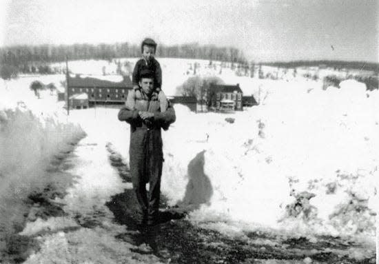 Paul McCleary, who worked and lived at the Horn Farm when he was younger, is seen with Larry Gordon on his shoulders. The Horn Farm is seen, background, in 1958, before construction of Route 30.