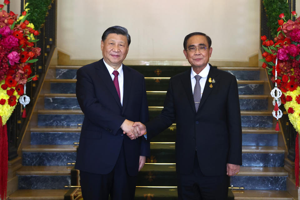 Chinese President Xi Jinping, left, shakes hands with Thai Prime Minister Prayuth Chan-ocha on the sidelines of the Asia-Pacific Economic Cooperation (APEC) summit in Bangkok, Thailand, Saturday, Nov. 19, 2022. (Athit Perawongmetha/Pool Photo via AP)