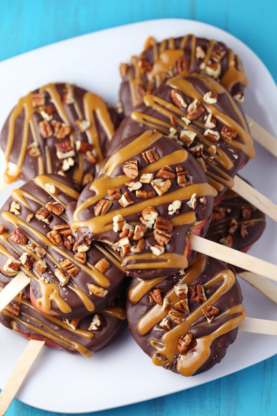 <p>This bite-size version of <a rel="nofollow noopener" href="https://www.womansday.com/food-recipes/food-drinks/g2573/how-to-make-caramel-apples/" target="_blank" data-ylk="slk:caramel apples;elm:context_link;itc:0;sec:content-canvas" class="link ">caramel apples</a> is the ultimate fall treat.</p><p><strong>Get the recipe at <a rel="nofollow noopener" href="http://www.momlovesbaking.com/chocolate-turtle-apple-slices/" target="_blank" data-ylk="slk:Mom Loves Baking;elm:context_link;itc:0;sec:content-canvas" class="link ">Mom Loves Baking</a>.</strong></p>