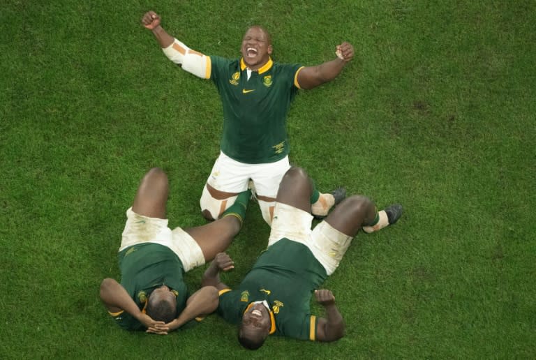 Hooker Bongi Mbonambi (C) and props Ox Nche (L) and Trevor Nyakane celebrate after <a class="link " href="https://sports.yahoo.com/soccer/teams/south-africa-women/" data-i13n="sec:content-canvas;subsec:anchor_text;elm:context_link" data-ylk="slk:South Africa;sec:content-canvas;subsec:anchor_text;elm:context_link;itc:0">South Africa</a> won the 2023 Rugby World Cup in Paris last October. (Antonin THUILLIER)