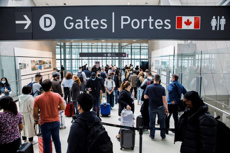 Travellers crowd the departures lounge at Toronto Pearson International Airport in Mississauga