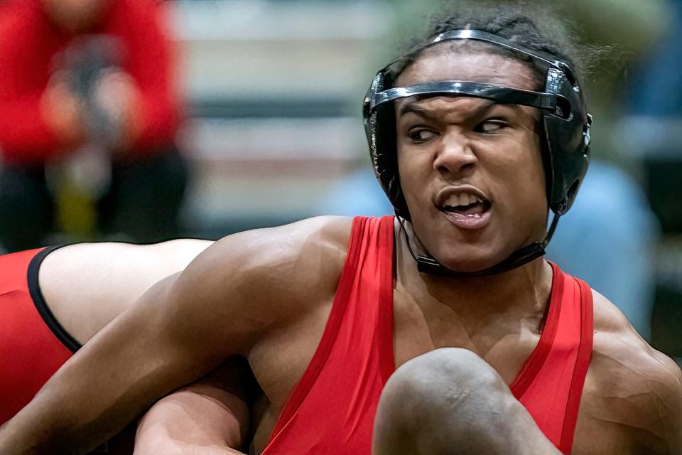 Galesburg High School senior Che Thomas grimaces as he competes against United High School's Chandler Talley in the 152 pound division during the eighth annual "Red Out Night" triple dual wrestling meet with the Silver Streaks, Red Storm and Knoxville on Tuesday, Jan. 18, 2022 at John Thiel Gymnasium.