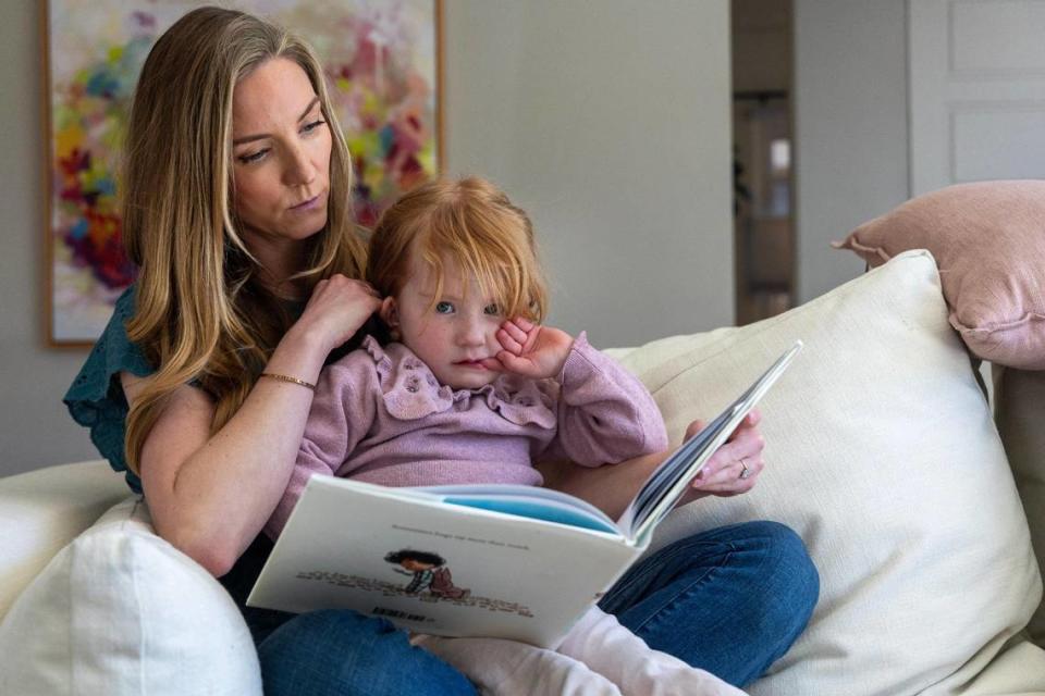 Lauren Lavelle reads a book to her daughter June, 4, at their Boise home in March. June underwent a tongue-tie release when she was 3 days old.