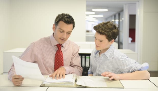 Teenage boy and businessman in office