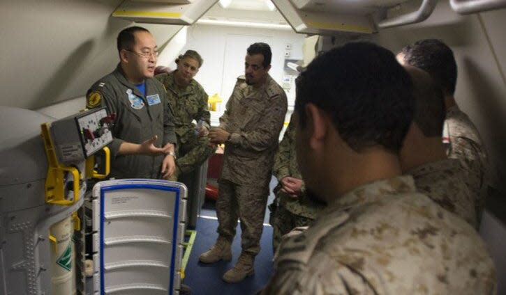 U.S. Navy Lt. Fan Yang, left, explains systems in the P-8A Poseidon aircraft in this 2018 photo.