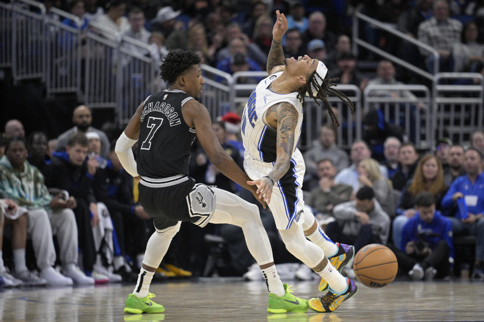 Orlando Magic guard Markelle Fultz, right, is fouled by San Antonio Spurs guard Josh Richardson (7) after stealing the ball from Richardson during the second half of an NBA basketball game Friday, Dec. 23, 2022, in Orlando, Fla. (AP Photo/Phelan M. Ebenhack)