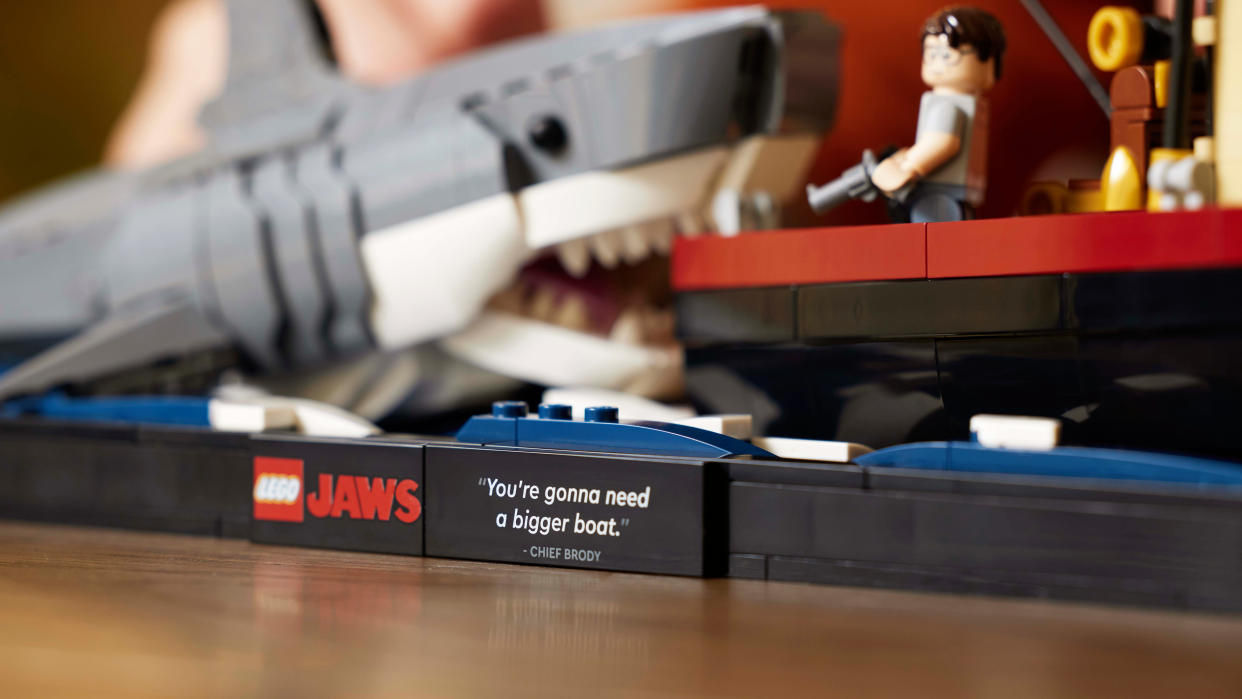  A close-up of the assembled LEGO Ideas Jaws set, showing the plaque bearing the 'We're gonna need a bigger boat' quote. 