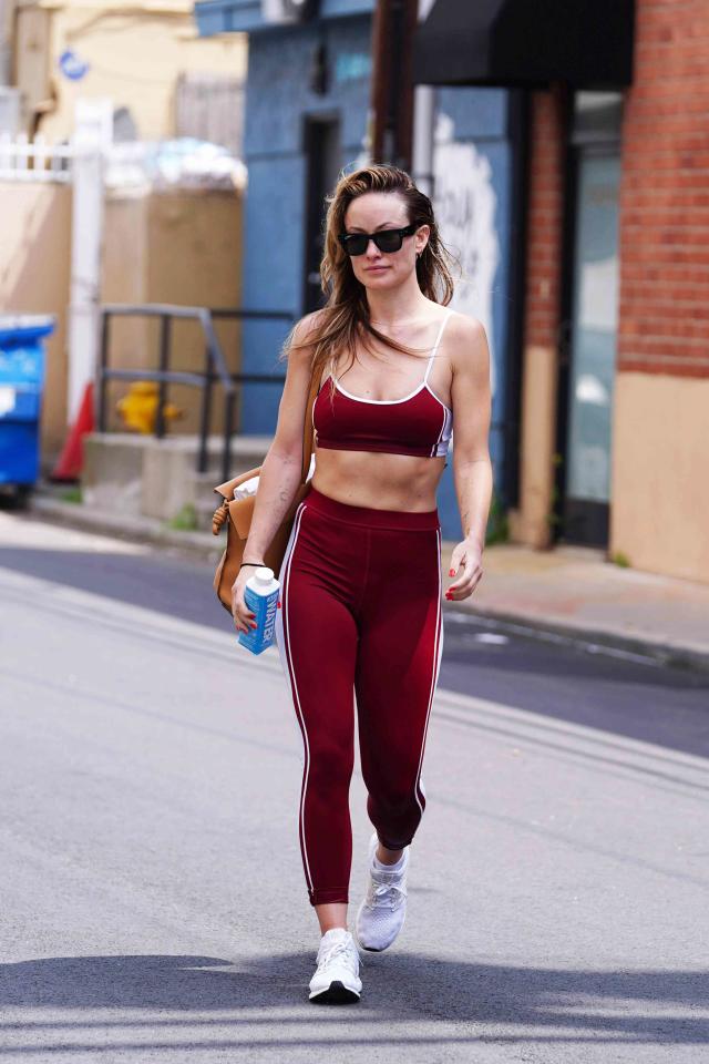 Olivia Wilde Wearing a Red Top, Black Yoga Pants and Sunglasses in