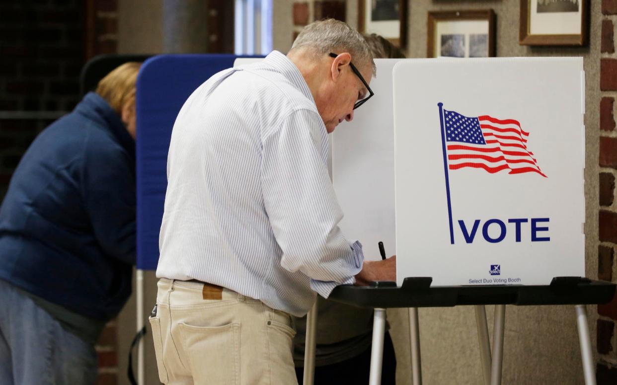 Voters cast their ballots at the Lincoln Park Fieldhouse poll during the election primary, Tuesday, August 9, 2022, in Manitowoc, Wis.