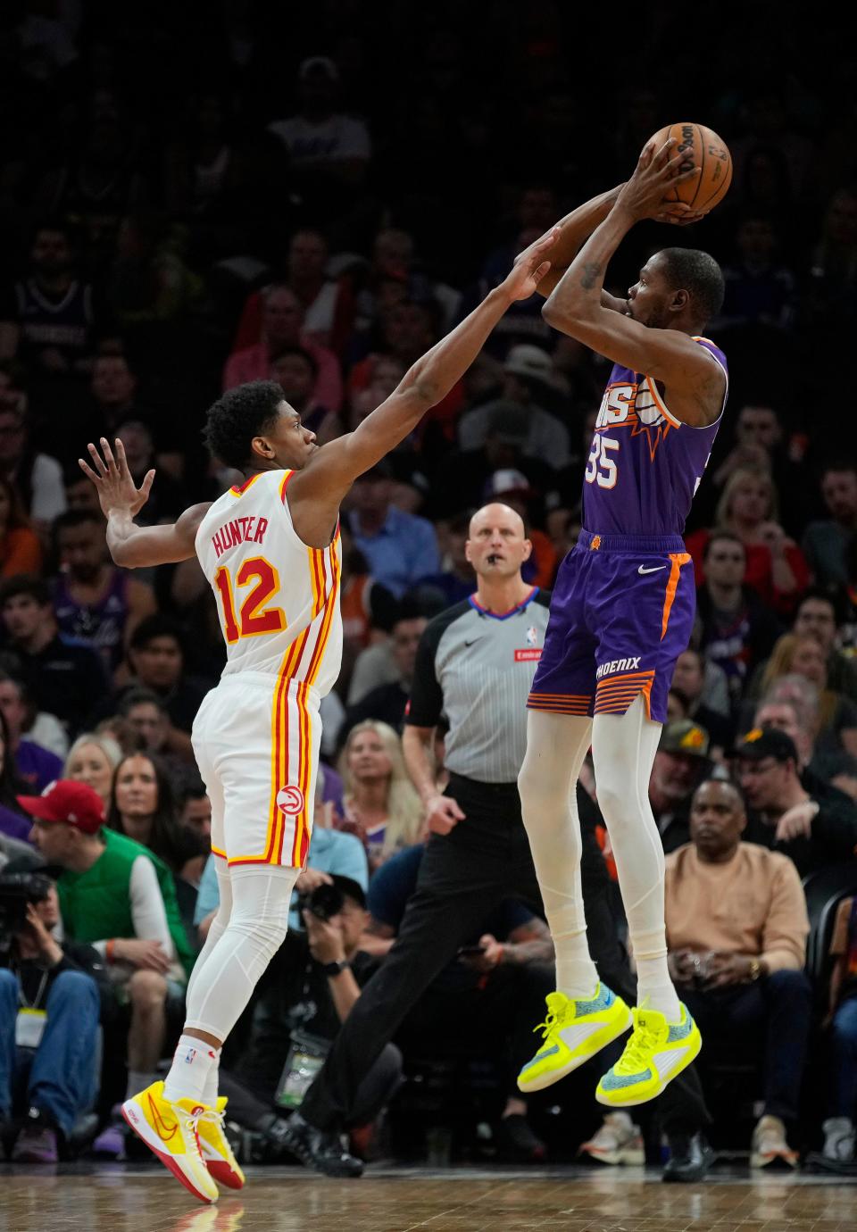 Suns forward Kevin Durant (35) shoots against Hawks forward De’Andre Hunter (12) during a game at the Footprint Center.