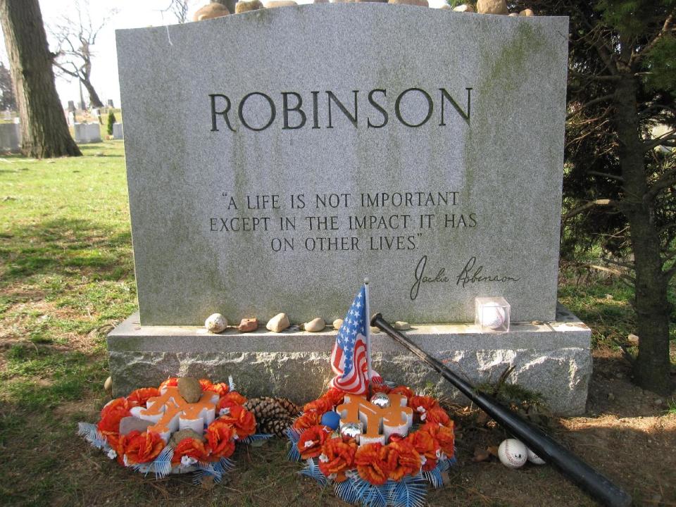 This April 9, 2013 photo shows Jackie Robinson’s gravesite, where fans still leave tributes to the man who integrated Major League Baseball when he joined the Brooklyn Dodgers in 1947. A new movie, “42,” about Robinson’s life is bringing his inspiring story to a new generation. Fans young and old can find a number of places in Brooklyn connected to Robinson, including his burial site in Cypress Hills Cemetery, which straddles the border of Brooklyn and Queens and is reachable via the Jackie Robinson Parkway. (AP Photo/Beth J. Harpaz)