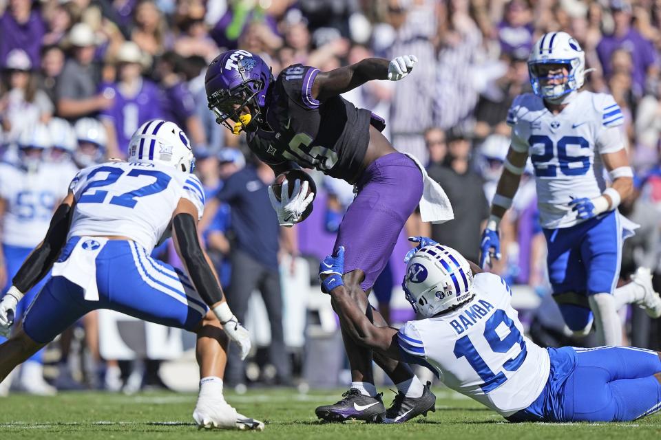 TCU wide receiver Dylan Wright (16) works for extra yards after making a catch against BYU defenders Mory Bamba (19) and Preston Rex (27) during the first half of an NCAA college football game Saturday, Oct. 14, 2023, in Fort Worth, Texas. | LM Otero, Associated Press