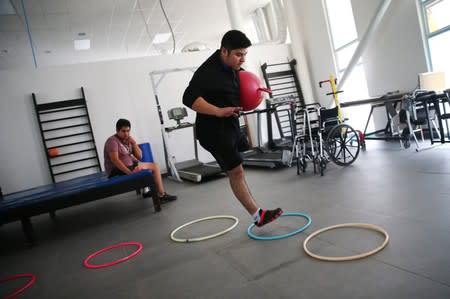 Migrants who lost legs attend a rehabilitation program