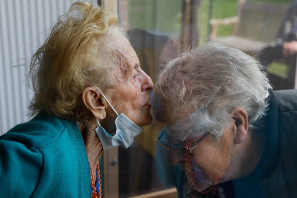 Illustration picture shows a visitor talking to a resident, as the visits to residents of rest homes are possible from today in Wallonia, here in Les Jardins d'Astrid, rest home in Maurage, La Louviere, visits are organised in a sas with plexiglas between resident and the relatives, Wednesday 29 April 2020. Belgium is in its seventh week of confinement in the ongoing corona virus crisis. The government has announced a phased plan to attempt an exit from the lockdown situation in the country, continuing to avoid the spread of Covid-19.
BELGA PHOTO THIERRY ROGE (Photo by THIERRY ROGE/BELGA MAG/AFP via Getty Images)