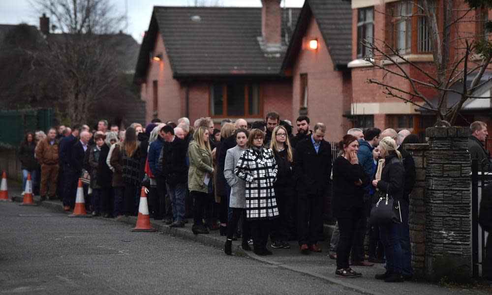 A long line of mourners queue to pay their respects at the home of Martin McGuinness. 