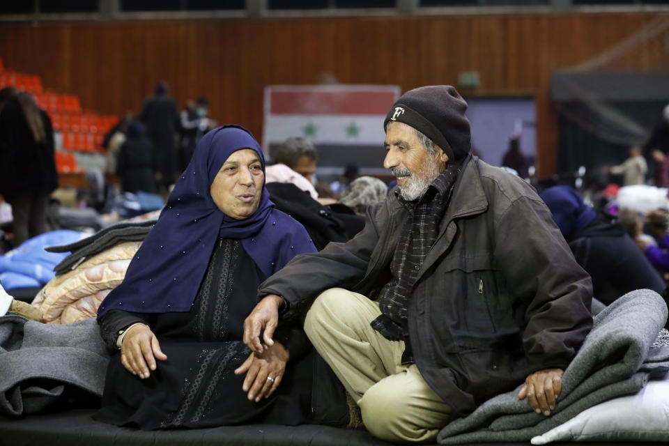 Displaced people sit inside a sports stadium following a devastating earthquake, in the coastal city of Latakia, Syria, Friday, Feb. 10, 2023. The 7.8 magnitude earthquake that hit Turkey and Syria, killing more than 23,000 this week has displaced millions of people in war-torn Syria. The country's 12-year-old uprising turned civil war had already displaced half the country's pre-war population of 23 million before the earthquake. (AP Photo/Omar Sanadiki)