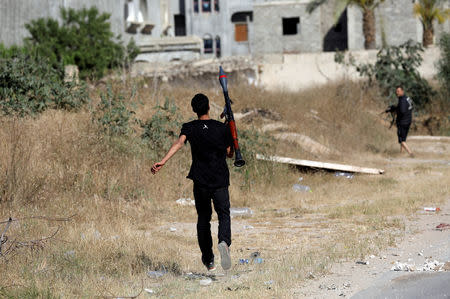 FILE PHOTO: A member of the Libyan internationally recognised government forces carries the RPG-7 during a fight with Eastern forces at al-Yarmouk south of Tripoli, Libya May 7, 2019. REUTERS/Hani Amara/File Photo