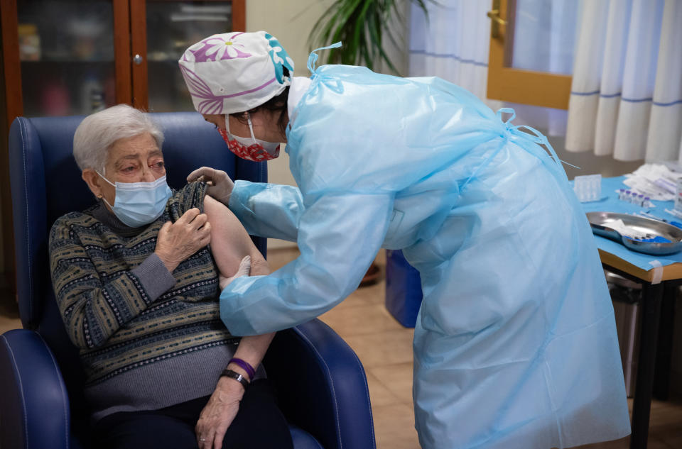 BARBASTRO, SPAIN - DECEMBER 27: In this handout photo, Lidia Navarro, 84, receives one of the first Pfizer/BioNTech Covid-19 vaccines in Spain at the Somontano nursing home on December 27, 2020 in Barbastro, Spain. Spain will begin to administer the coronavirus vaccine developed by Pfizer and BioNTech on December 27. With 1.84 million cases recorded since the start of the pandemic, Spain has reported almost 50,000 covid-19 deaths. (Photo by Alvaro Calvo/Government of Aragon via Getty Images)