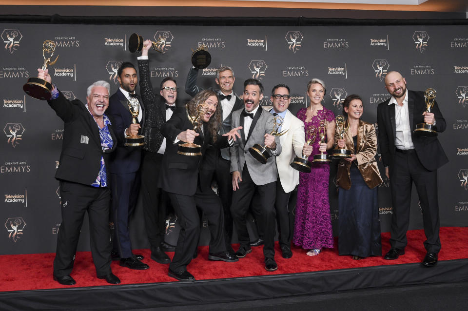 The team from "Weird: The Al Yankovic Story" pose in the press room with the award for outstanding television movie during night one of the Creative Arts Emmy Awards on Saturday, Jan. 6, 2024, at the Peacock Theater in Los Angeles. (Photo by Richard Shotwell/Invision/AP)
