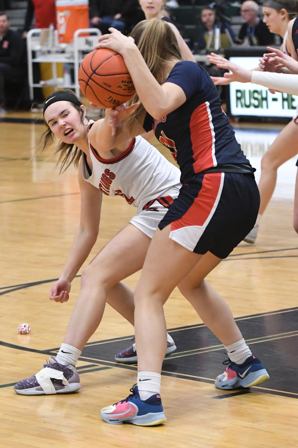 Chelsie Tyler of Dansville reaches in and tries to knock the ball awaye from Madelyn Moore of Dansville.
