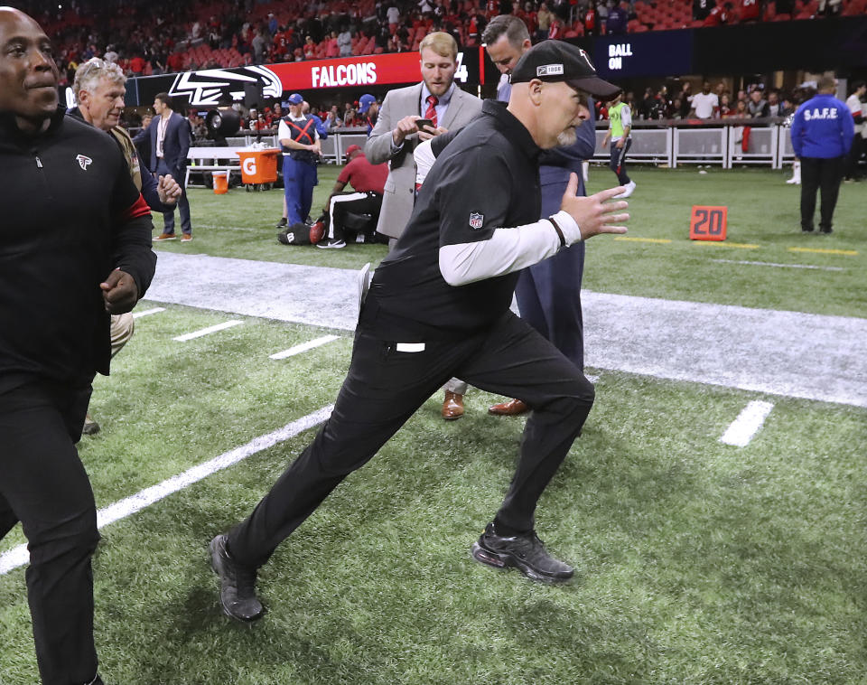 Atlanta Falcons head coach Dan Quinn dashes off the field with a 24-12 victory over the Jacksonville Jaguars during the final home game of the season in a NFL football game on Sunday, December 22, 2019, in Atlanta. (Curtis Compton/Atlanta Journal-Constitution via AP)