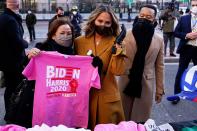 <p>John Legend, Chrissy Teigen and her mom Vilailuck stop for some Biden/Harris merch on Wednesday while in Washington, D.C., for the inauguration of President Joe Biden. </p>