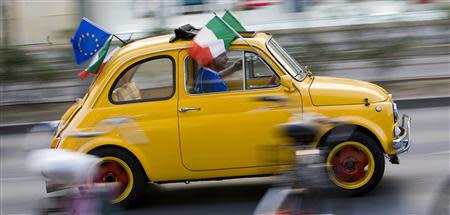 An Italy fan driving a Fiat car celebrates after the World Cup soccer match between Italy and Australia, in the streets of downtown Frankfurt in this June 26, 2006 file photograph. REUTERS/Miro Kuzmanovic/Files