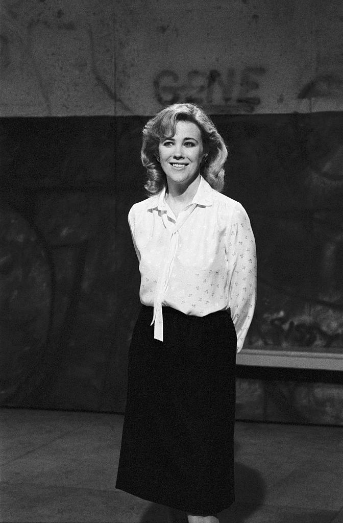 Black and white photo in 1984, wearing a prim blouse