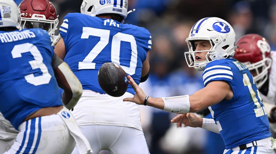 Brigham Young Cougars quarterback Jake Retzlaff (12) pitches the ball out to running back Aidan Robbins (3) as BYU and Oklahoma play at LaVell Edwards Stadium in Provo on Saturday, Nov. 18, 2023. | Scott G Winterton, Deseret News