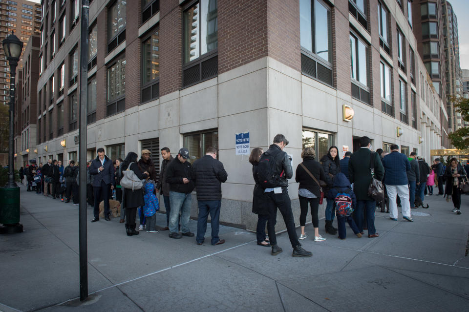 People stand in line outside a polling station located at Trump Place in New York, on Nov. 8.