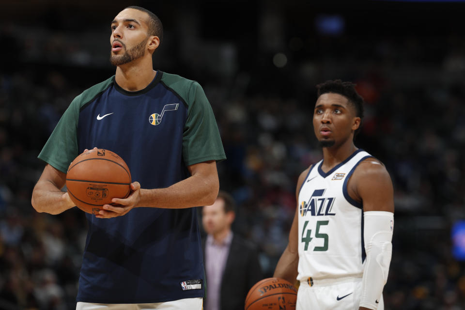 Utah Jazz center Rudy Gobert (27) and Utah Jazz guard Donovan Mitchell (45) in the second half of an NBA basketball game Saturday, Nov. 3, 2018, in Denver. The Nuggets won 103-88. (AP Photo/David Zalubowski)