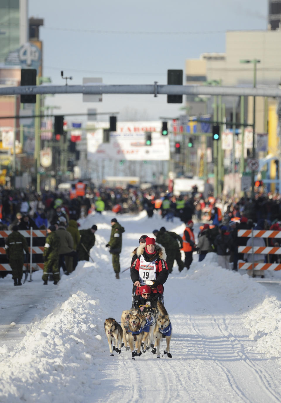 Iditarod veteran Aliy Zirkle runs down her team down Fourth Ave. during the ceremonial start of the Iditarod Trail Sled Dog Race, Saturday, March 2, 2019 in Anchorage, Alaska. (AP Photo/Michael Dinneen)