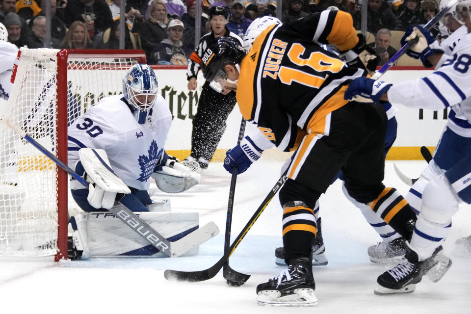 Pittsburgh Penguins' Jason Zucker (16) can't gain control of the puck in front of Toronto Maple Leafs goaltender Matt Murray (30) during the second period of an NHL hockey game in Pittsburgh, Tuesday, Nov. 15, 2022. (AP Photo/Gene J. Puskar)