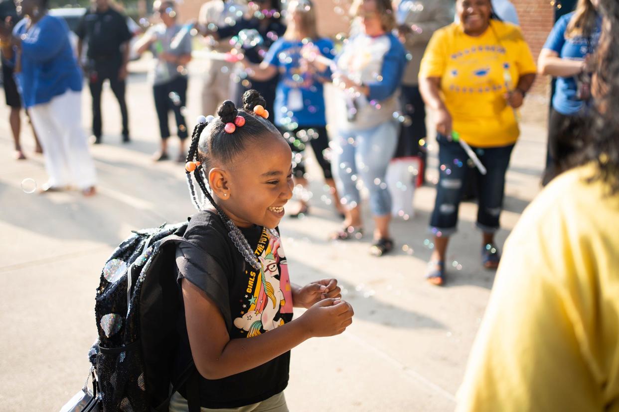 Jul 26, 2023; Columbus, Ohio, USA;  Second grader, Trinity Dodd, is clapped in at Woodcrest Elementary School by teachers and staff, on the first day of school. Woodcrest Elementary School is the district's only year-round school.