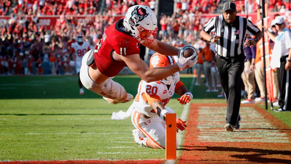 N.C. State linebacker Payton Wilson (11) dives in to score on a 15-yard touchdown interception during the second half of N.C. State’s 24-17 victory over Clemson at Carter-Finley Stadium in Raleigh, N.C., Saturday, Oct. 28, 2023. Ethan Hyman/ehyman@newsobserver.com