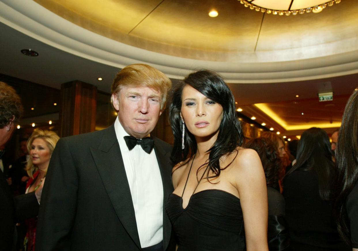 Donald Trump and Melania Knauss pose as they arrive for a charity event on board the Queen Mary 2 on April 24, 2004 in New York.