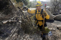 Frankie Aguirre, of the Jamul Fire Dept., out of San Diego County, clears brush while fighting the Highland Fire Tuesday, Oct. 31, 2023, in Aguanga, Calif. (AP Photo/Marcio Jose Sanchez)