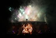 Fireworks go off over a flaming depiction of William Shakespeare during a firework display at the Royal Shakespeare Company marking the 450th anniversary of Shakespeare's birth in Stratford-upon-Avon, southern England April 23, 2014. Known as the Bard and regarded as England's greatest playwright, Shakespeare, whose 450th birthday is celebrated on Wednesday, let his imagination roam as widely as his characters. REUTERS/Suzanne Plunkett (BRITAIN - Tags: SOCIETY)