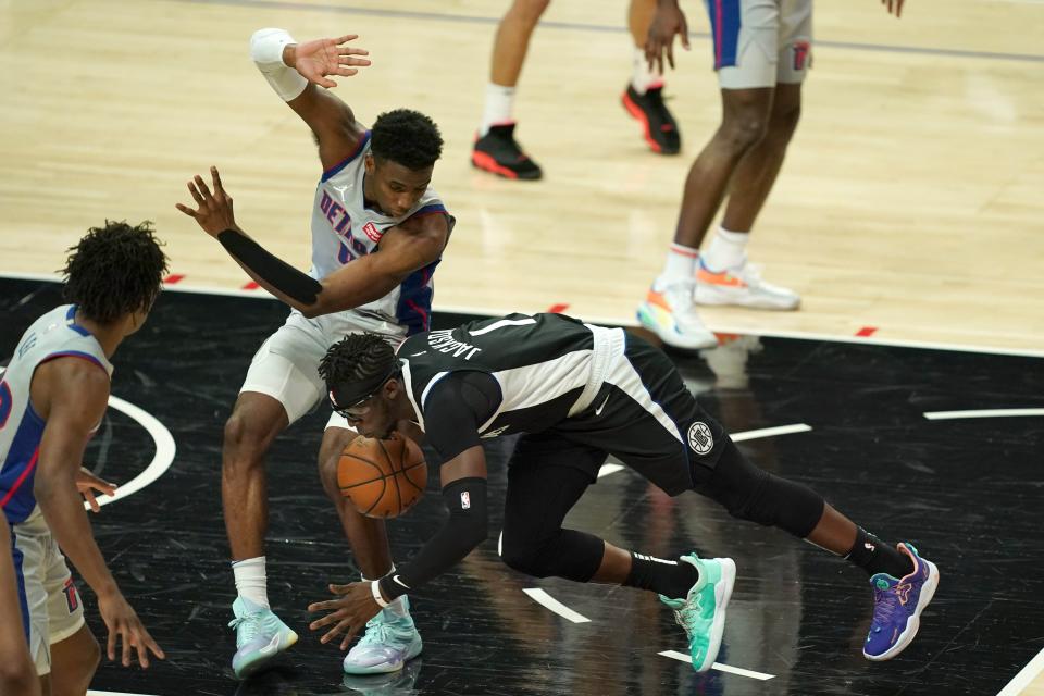 LA Clippers guard Reggie Jackson (1) collides with Detroit Pistons guard Hamidou Diallo (6) in the first half April 11, 2021 at Staples Center.