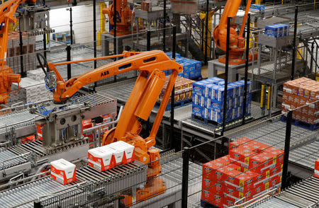 Robotic arms load biscuits onto pallets on the production line of Pladis' McVities factory in London Britain, September 19, 2017. Picture taken September 19, 2017. REUTERS/Peter Nicholls.
