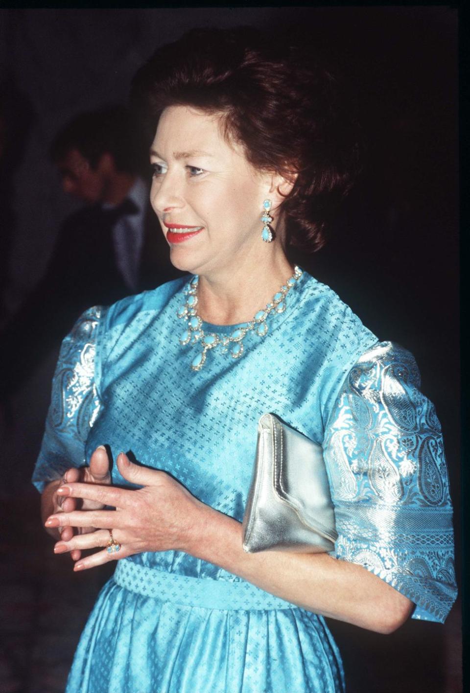 <p>The Princess wears a blue gown and matching blue jewelry at the opening of the Theatre Royal in Bath in 1982.</p>