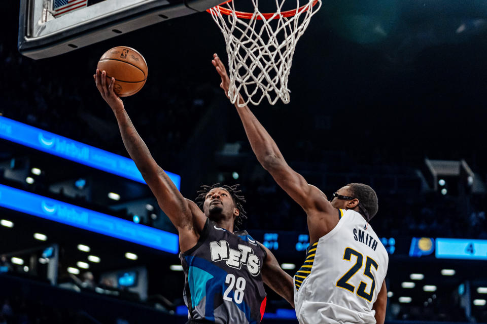 Brooklyn Nets forward Dorian Finney-Smith (28) shoots next to Indiana Pacers' Jalen Smith (25) during the first half of an NBA basketball game in New York, Wednesday, April 3, 2024. (AP Photo/Peter K. Afriyie)