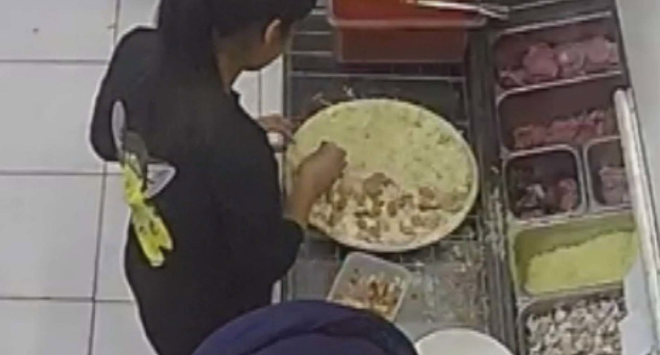 CCTV footage of the pizza being made at In this image a screw is seen inside a prawn and pineapple pizza from Bradman Pizza House in Cowandilla in Adelaide. 