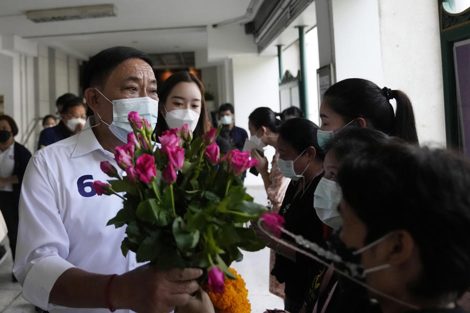 Bangkok governor independent candidate Asawin Kwanmuang received flower from his supporters during an election campaign in Bangkok, Thailand, Tuesday, May 17, 2022. Residents of the Thai capital Bangkok will cast their ballots for the city’s leader Sunday in a vote seen as a barometer of the public mood ahead of an approaching general election. (AP Photo/Sakchai Lalit)